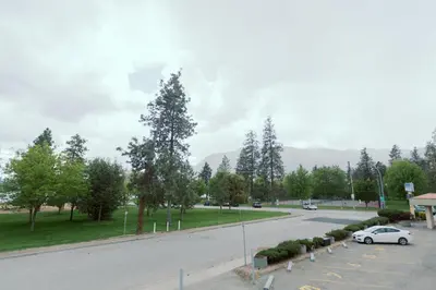a car parked in a parking lot next to a street at Waterfront Inn in Penticton