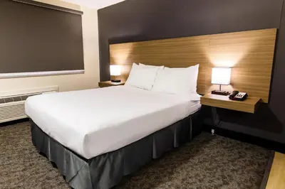 a large white bed in a hotel room at SureStay by Best Western Smithers in Smithers