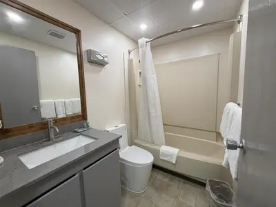 a bathroom with a sink and a toilet and a shower at SureStay by Best Western Smithers in Smithers