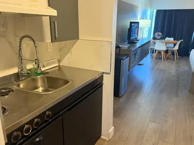 a kitchen with a sink and a counter top at Sand Pebbles Inn in Qualicum Beach