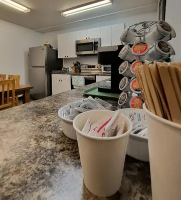 a kitchen with a counter with dishes on it at Fireweed Motel in Smithers