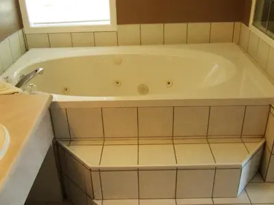 a white bath tub in a bathroom with a window at Ponderosa Motor Inn in Golden