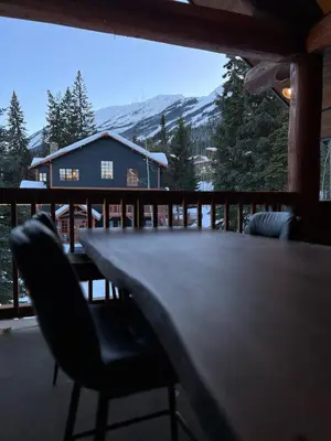 a table and chairs on the deck of a cabin at Winston Lodge in Golden