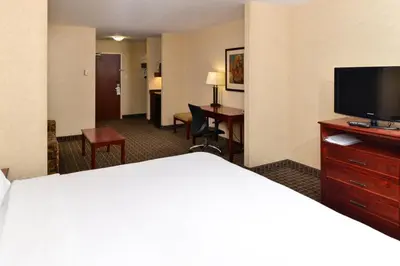 a hotel room with a bed and a flat screen tv at Holiday Inn Express Edmonton North by IHG in Edmonton