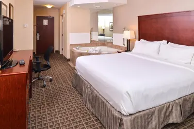 a hotel room with a large bed and a bathroom at Holiday Inn Express Edmonton North by IHG in Edmonton