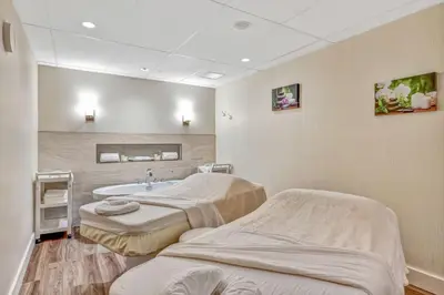 a hospital room with two beds and a sink at Oceanfront Suites at Cowichan Bay in Cowichan Bay