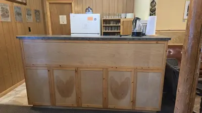 a bar with a counter with a microwave on top at Black Cat Guest Ranch in Brule Mines