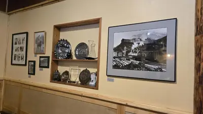 a room with a picture of a train on the wall at Black Cat Guest Ranch in Brule Mines