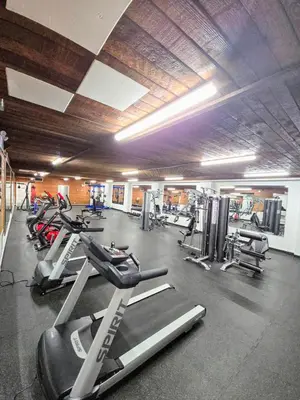 a gym with a bunch of tread machines in it at Crestwood Hotel in Hinton
