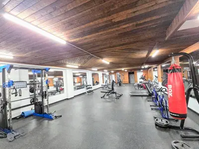a gym with a bunch of machines in it at Crestwood Hotel in Hinton