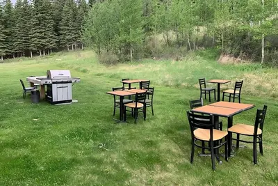 a group of tables and chairs in a field at Super 8 by Wyndham Hinton-Free Breakfast,Wifi,Parking in Hinton