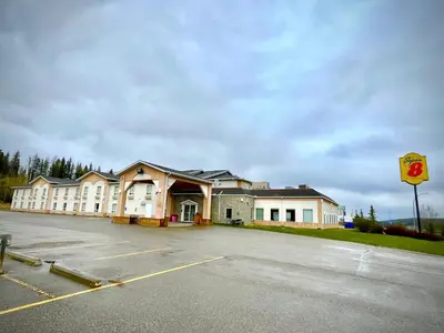 an empty parking lot in front of a building at Super 8 by Wyndham Hinton-Free Breakfast,Wifi,Parking in Hinton