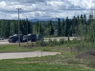 a truck is parked on the side of a road at Super 8 by Wyndham Hinton-Free Breakfast,Wifi,Parking in Hinton