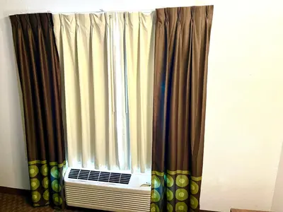 a window with curtains in a room at Super 8 by Wyndham Hinton-Free Breakfast,Wifi,Parking in Hinton
