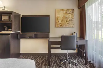 a hotel room with a desk and a television at Best Western Wayside Inn in Wetaskiwin