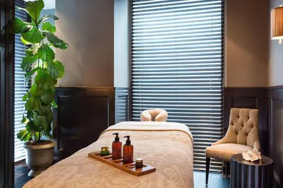 a room with a bed with two bottles of alcohol at Rosewood Hotel Georgia in Vancouver