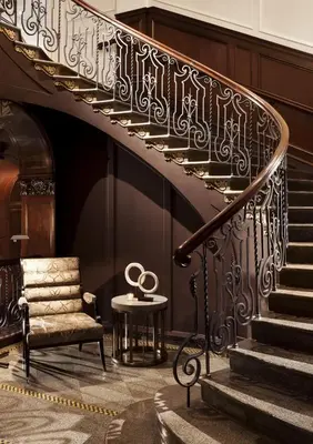 a room with a staircase with a statue of the olympics at Rosewood Hotel Georgia in Vancouver