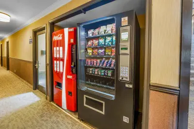 a cocacola soda machine in a hallway at Days Inn by Wyndham Terrace in Terrace