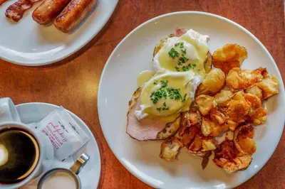 a plate of breakfast food with eggs and potatoes at Days Inn by Wyndham Terrace in Terrace