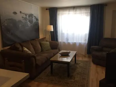 a living room with a couch and a coffee table at Black Rooster Guesthouse in Prince Rupert