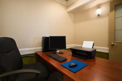 an office with a desk with a computer and a printer at Days Inn by Wyndham High Level in High Level
