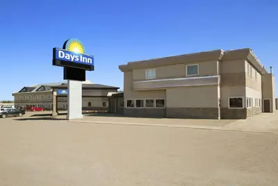 a days inn sign in front of a building at Days Inn by Wyndham High Level in High Level