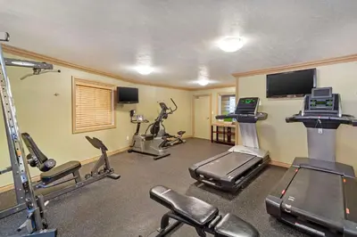 a fitness room with treadmills and cardio machines at Best Western PLUS Mirage Hotel and Resort in High Level