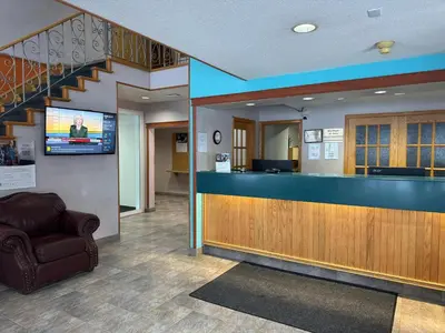 a lobby with a waiting room with a bar at Howard Johnson by Wyndham Fort St. John in Fort Saint John