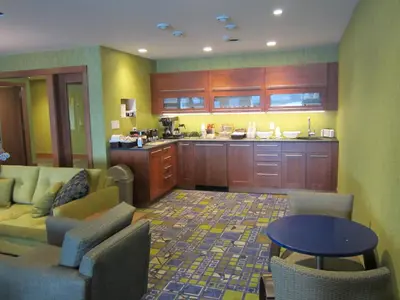 a living room with a couch and a kitchen at Inn on the Harbour in Prince Rupert