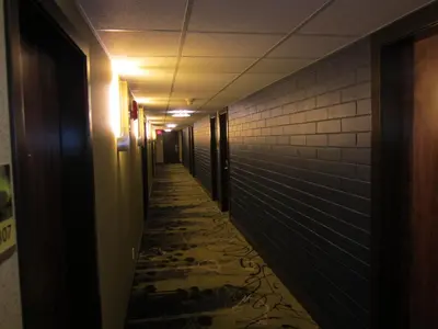an empty hallway with a long aisle in a building at Inn on the Harbour in Prince Rupert
