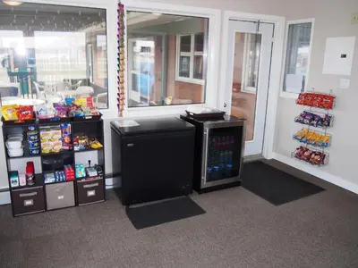 a store with a soda machine in a room at Airways Motel in Cold Lake