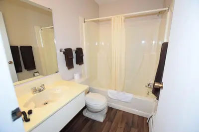 a bathroom with a sink and a toilet and a shower at Airways Motel in Cold Lake