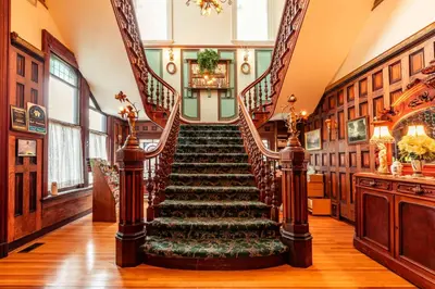 a spiral staircase in a home with a stair case at Amethyst Inn in Victoria
