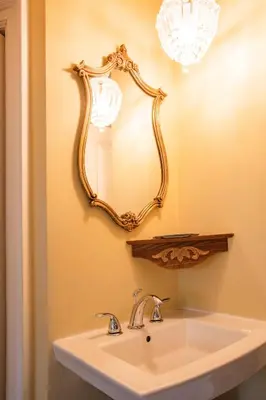 a bathroom with a sink and a mirror on the wall at Amethyst Inn in Victoria