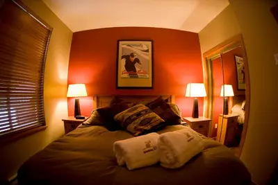 a bedroom with a bed with two towels on it at Whistler Superior Properties in Whistler