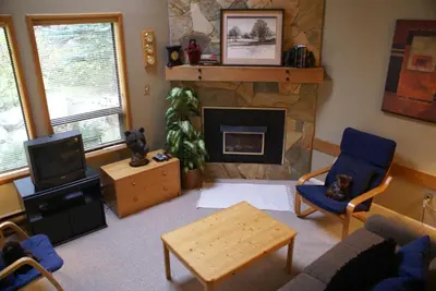 a living room with a couch and a fireplace at Whistler Superior Properties in Whistler