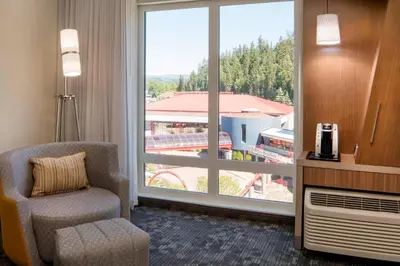 a room with a chair and a large window at Courtyard by Marriott Prince George in Prince George