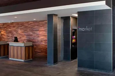 a lobby with a market sign on a brick wall at Courtyard by Marriott Prince George in Prince George