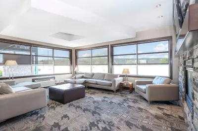 a large living room with couches and a fireplace at Sandman Hotel & Suites Prince George in Prince George