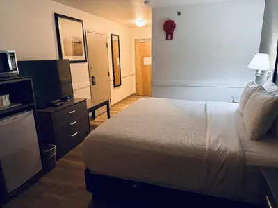 a hotel room with a bed and a television at Super 8 by Wyndham Dawson Creek in Dawson Creek