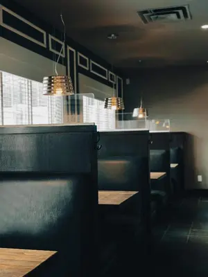 a dining room with black chairs and a bar at Super 8 by Wyndham Dawson Creek in Dawson Creek