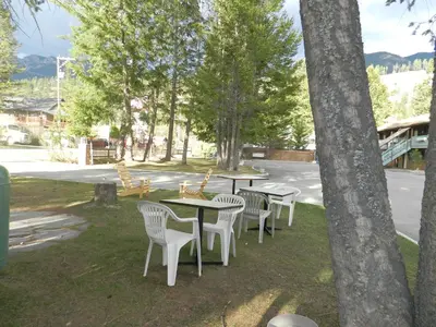a row of tables and chairs in a park at Motel Bavaria in Radium Hot Springs