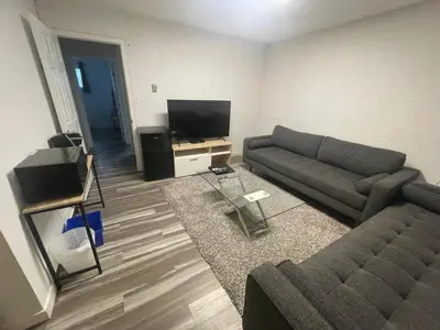 a living room with a couch and a flat screen tv at Crystal Springs Lodge in Radium Hot Springs