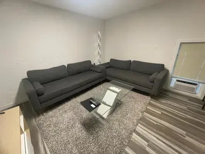 a living room with a couch and a table at Crystal Springs Lodge in Radium Hot Springs