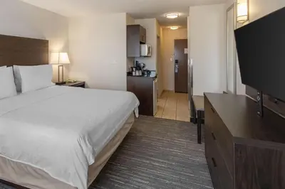 a hotel room with a bed and a flat screen tv at Best Western Dawson Creek in Dawson Creek