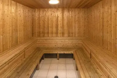a wooden sauna with a bench in the middle at Best Western Dawson Creek in Dawson Creek
