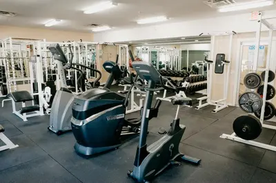 a gym with several treadmills and exercise bikes at Ramada Golden in Golden