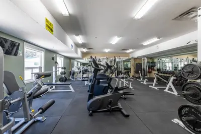 a gym with lots of treadmills and machines at Ramada Golden in Golden