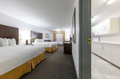 a hotel room with two beds and a kitchen at Ramada Golden in Golden