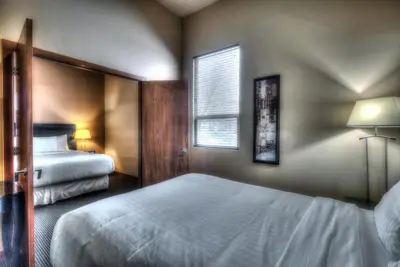 a bedroom with two beds and a window at Podollan Inn & Spa - Grande Prairie in Grande Prairie